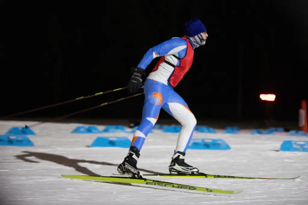 Professional skier in Fischer gear skiing past the camera.