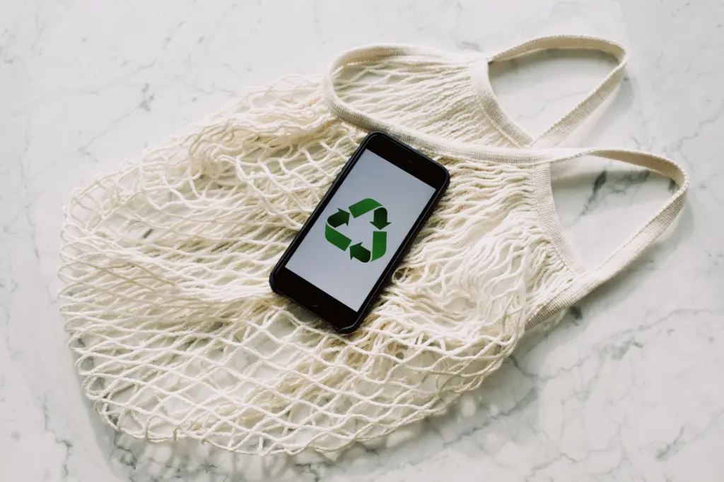 Sustainable bag and mobile phone with recycling symbo