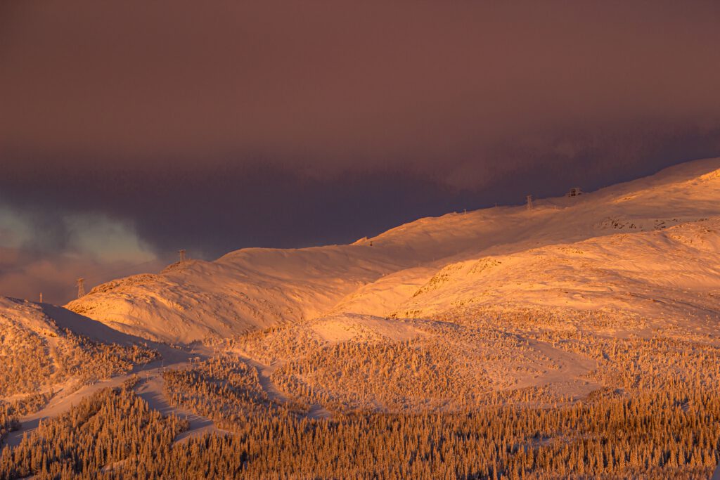 A breathtaking aerial view of the snow-capped mountain slopes in Åre, Sweden, a perfect destination for skiing enthusiasts.